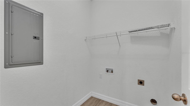 washroom featuring hardwood / wood-style floors, washer hookup, hookup for an electric dryer, and electric panel