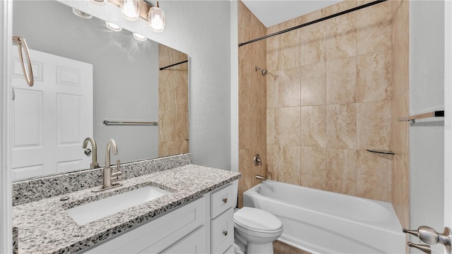 full bathroom with vanity, toilet, and tiled shower / bath combo