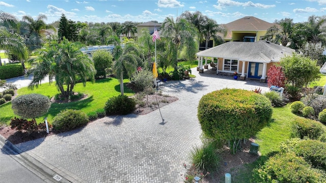 751 Meandering Way, Polk City, FL 33868 - exterior space with decorative driveway and a front lawn