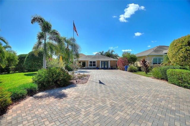 751 Meandering Way, Polk City, FL 33868 - view of front of home featuring decorative driveway and a front lawn