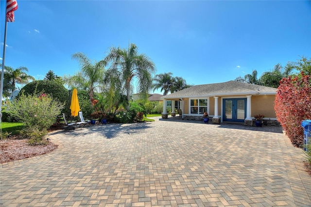 751 Meandering Way, Polk City, FL 33868 - view of front of house featuring stucco siding and french doors