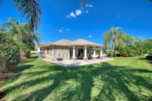 751 Meandering Way, Polk City, FL 33868 - back of house with a patio area, stucco siding, central AC, and a yard