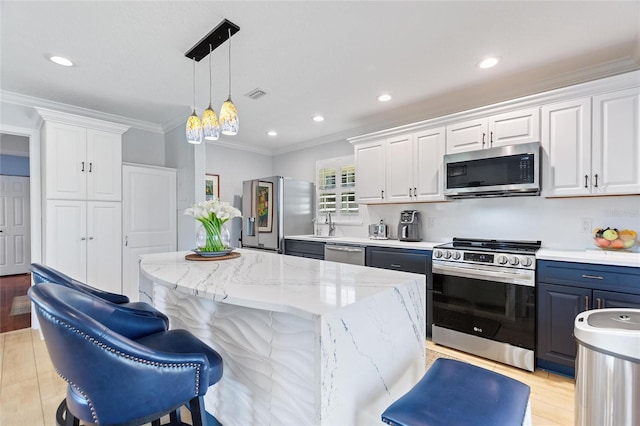 751 Meandering Way, Polk City, FL 33868 - kitchen featuring decorative light fixtures, stainless steel appliances, visible vents, ornamental molding, and white cabinets