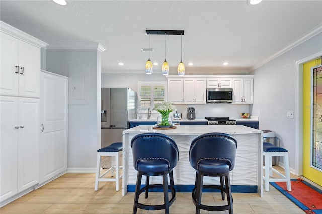 751 Meandering Way, Polk City, FL 33868 - kitchen with a center island, hanging light fixtures, stainless steel appliances, a kitchen bar, and white cabinetry