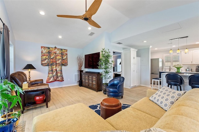 751 Meandering Way, Polk City, FL 33868 - living room featuring baseboards, visible vents, vaulted ceiling, and light wood finished floors