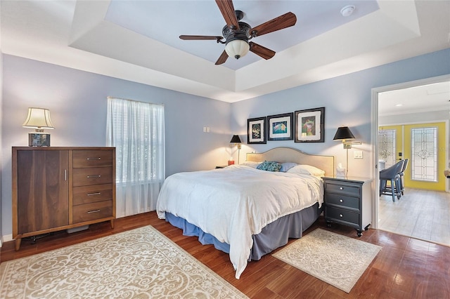 751 Meandering Way, Polk City, FL 33868 - bedroom with ceiling fan, dark wood-type flooring, and a raised ceiling