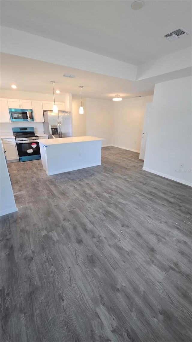 unfurnished living room with dark wood-type flooring