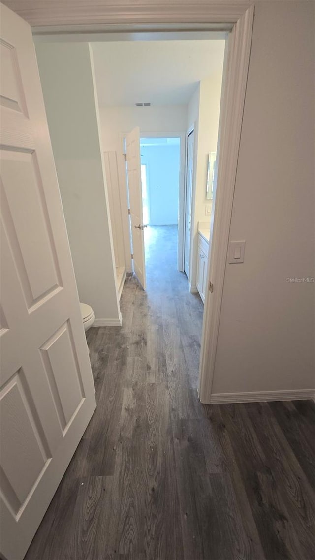 hallway with dark hardwood / wood-style flooring