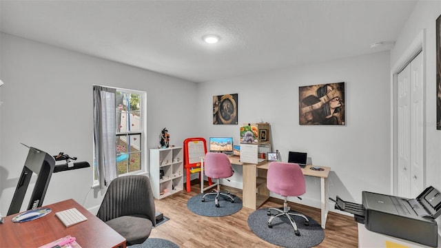 office space with wood finished floors and baseboards