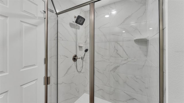 bathroom with a marble finish shower