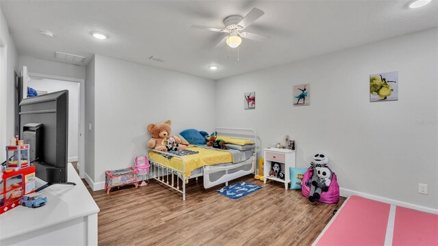 bedroom featuring recessed lighting, wood finished floors, baseboards, and ceiling fan