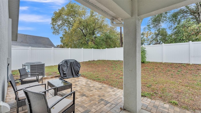 view of patio / terrace with central AC, a fenced backyard, and a grill