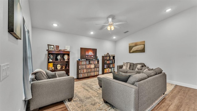 living room with recessed lighting, a ceiling fan, light wood-type flooring, and baseboards