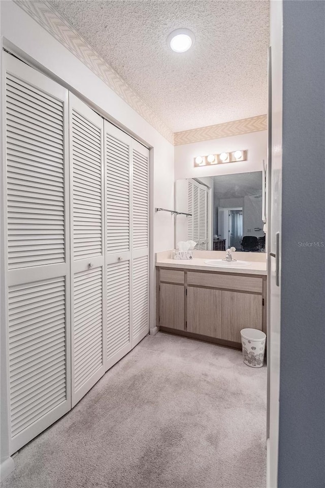 bathroom with vanity and a textured ceiling