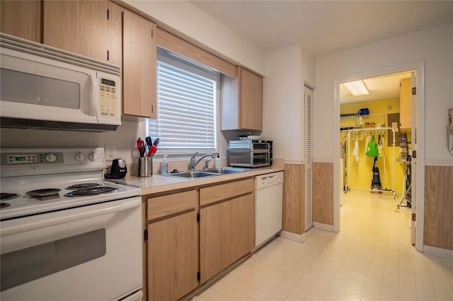 kitchen with white appliances, sink, and light brown cabinets