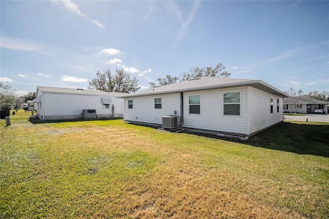 back of property featuring a yard and central AC unit