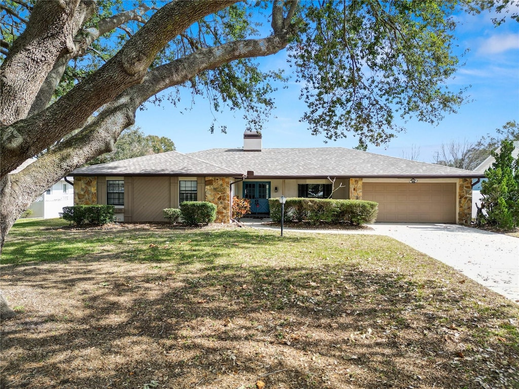 ranch-style house with a garage and a front yard