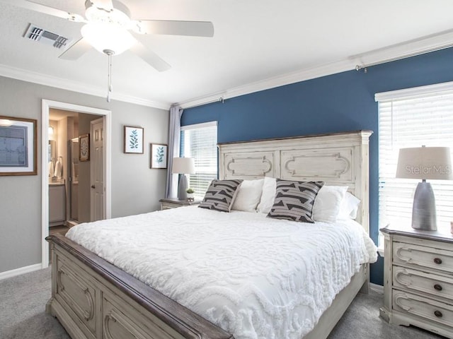 carpeted bedroom featuring ensuite bath, ornamental molding, and ceiling fan