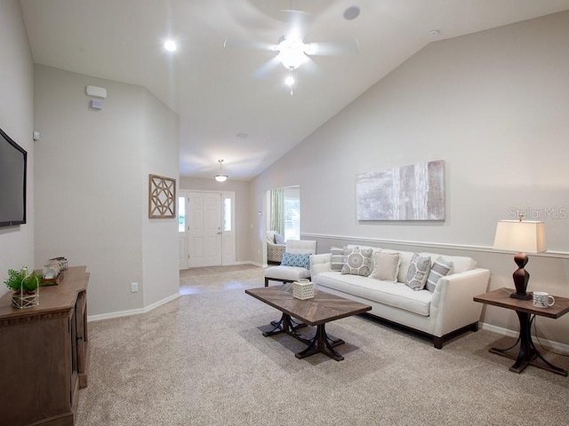 carpeted living room featuring high vaulted ceiling