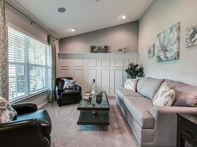 living room with lofted ceiling, carpet flooring, and a wealth of natural light