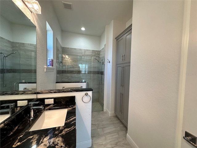 bathroom featuring walk in shower and vanity