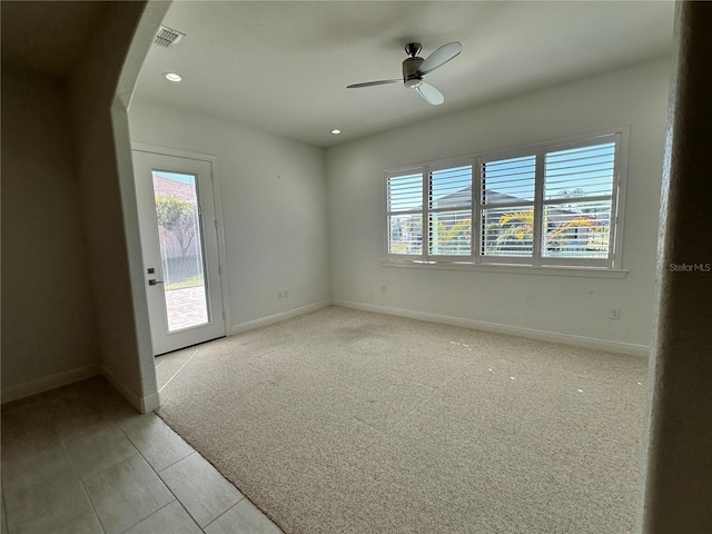 carpeted empty room with ceiling fan and a healthy amount of sunlight