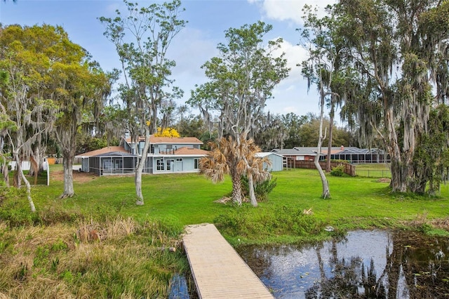 view of dock featuring a yard and a water view