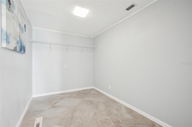 spacious closet featuring visible vents