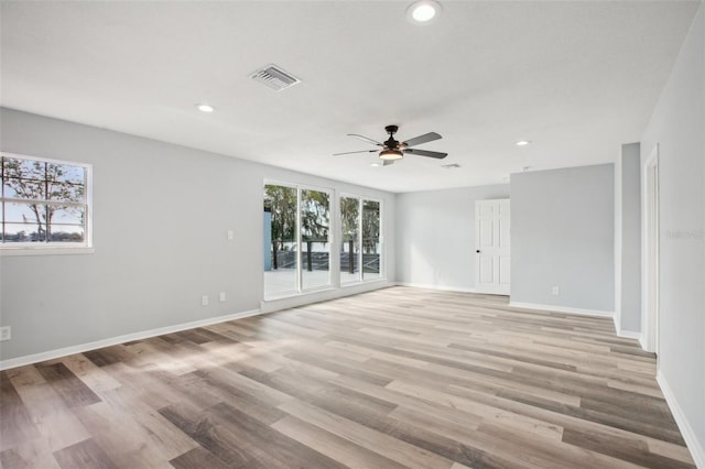 empty room featuring recessed lighting, baseboards, visible vents, and light wood finished floors