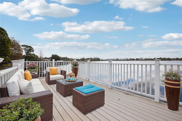 wooden deck with outdoor lounge area and a water view