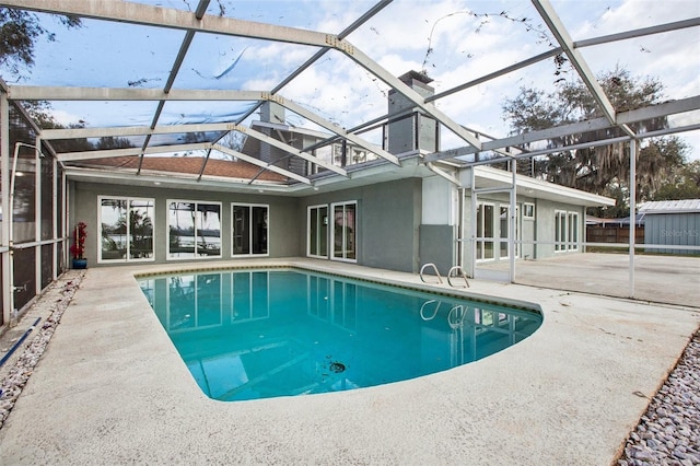 outdoor pool featuring a patio area and a lanai