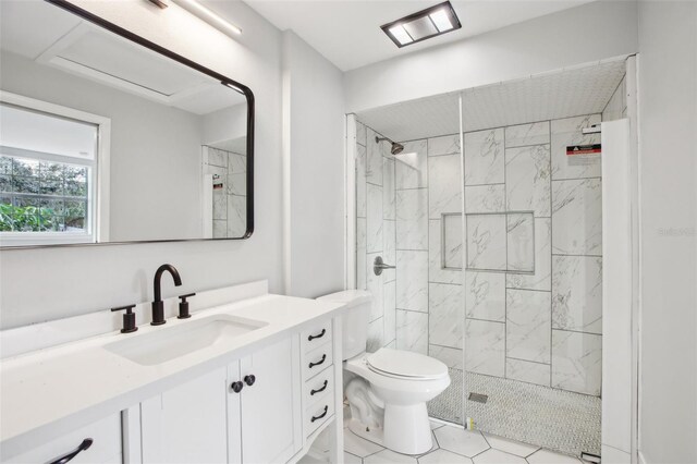 bathroom featuring toilet, a shower stall, and vanity