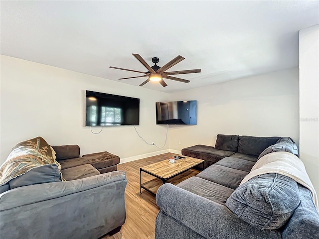 living room featuring wood-type flooring and ceiling fan