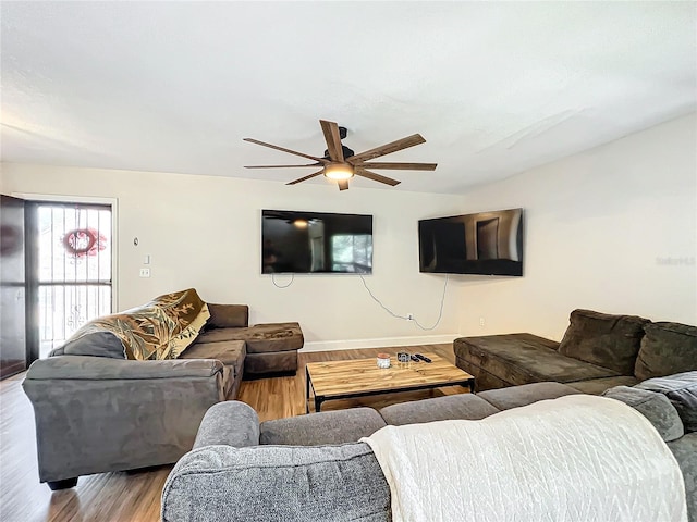 living room featuring ceiling fan and light hardwood / wood-style flooring