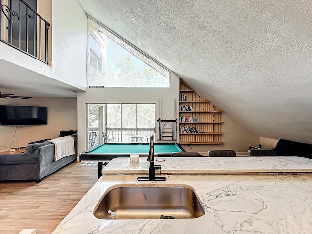 recreation room featuring pool table, wood-type flooring, sink, and a high ceiling