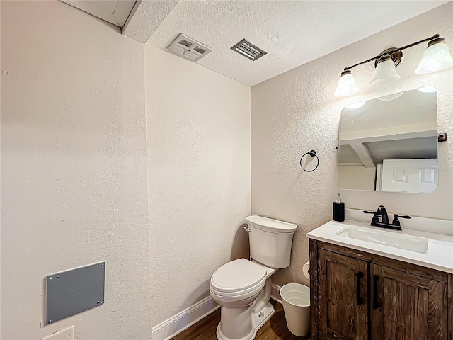 bathroom with vanity, a textured ceiling, toilet, and hardwood / wood-style flooring