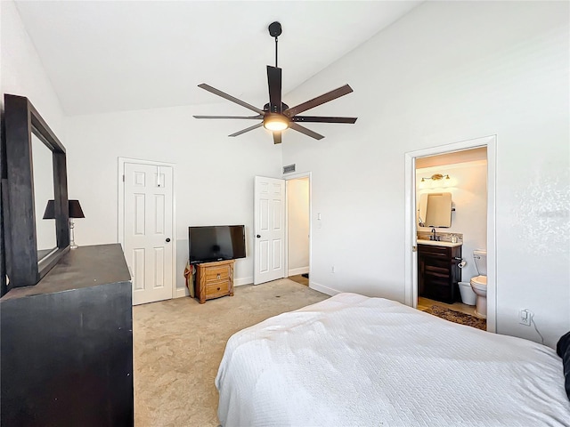 bedroom with sink, ceiling fan, high vaulted ceiling, connected bathroom, and light carpet