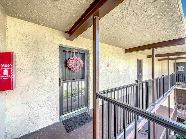 view of exterior entry featuring a balcony