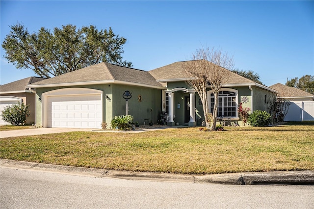 ranch-style house with a garage and a front yard