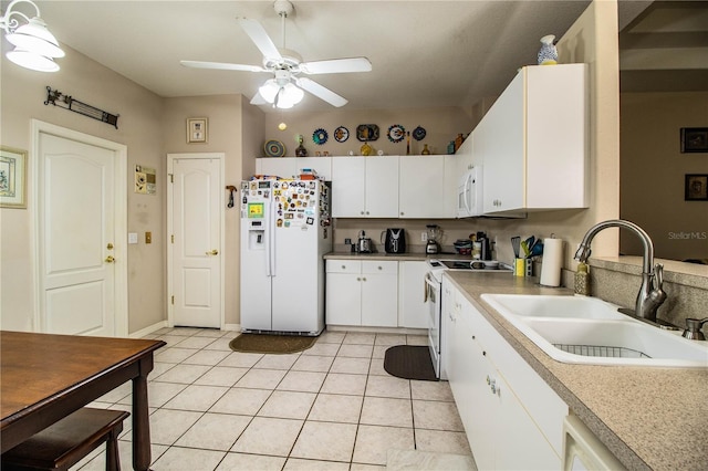 kitchen with sink, white cabinets, light tile patterned floors, ceiling fan, and white appliances