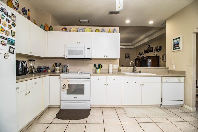 kitchen featuring white cabinetry, sink, light tile patterned floors, and white appliances