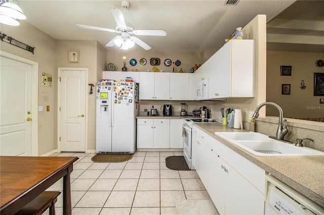 kitchen featuring sink, white cabinetry, light tile patterned floors, ceiling fan, and white appliances