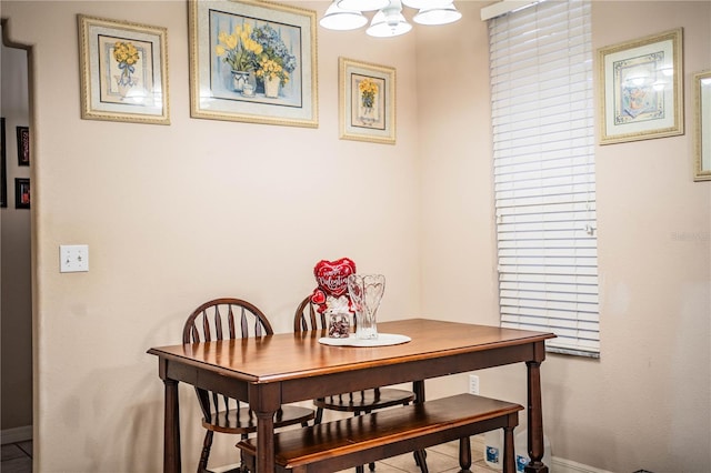 dining area with an inviting chandelier