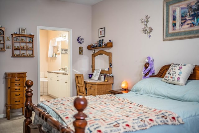 carpeted bedroom with ensuite bath and sink