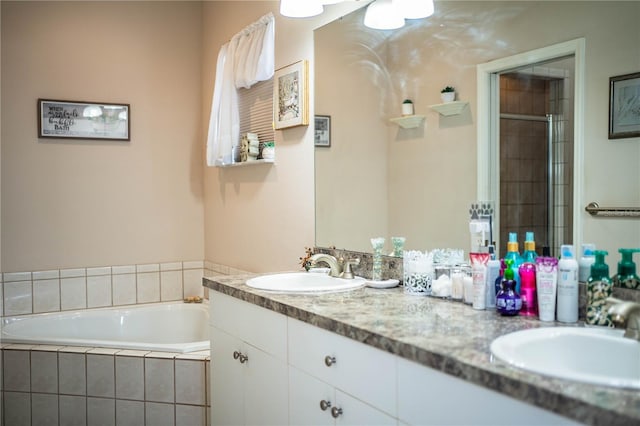 bathroom featuring vanity and shower with separate bathtub