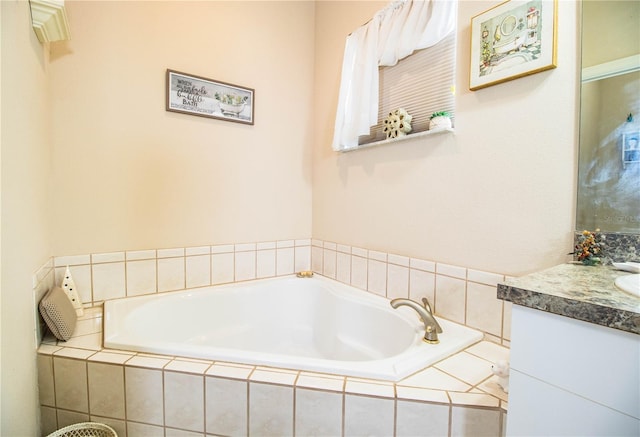 bathroom with vanity and tiled tub