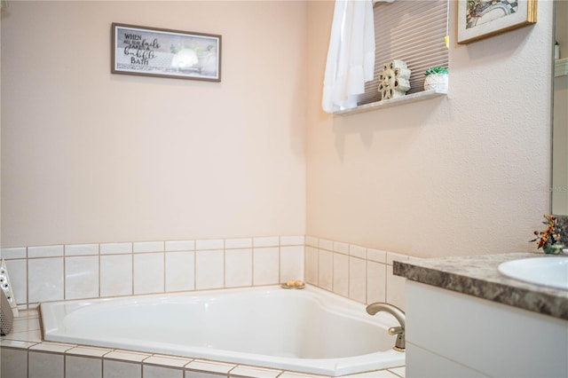 bathroom featuring vanity and tiled bath