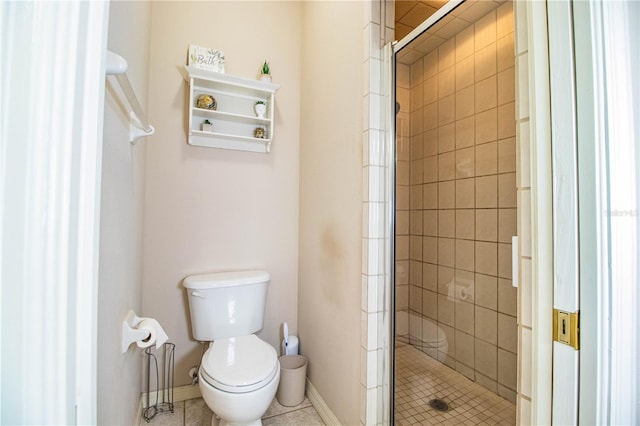 bathroom featuring tile patterned floors, toilet, and a shower with door