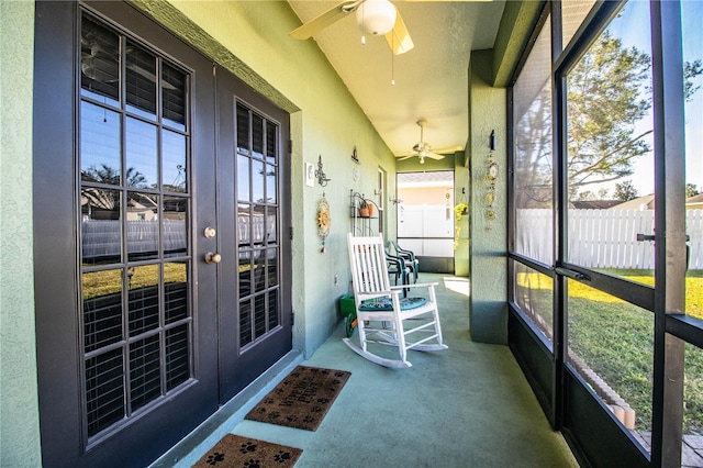 sunroom / solarium featuring french doors, ceiling fan, vaulted ceiling, and a wealth of natural light