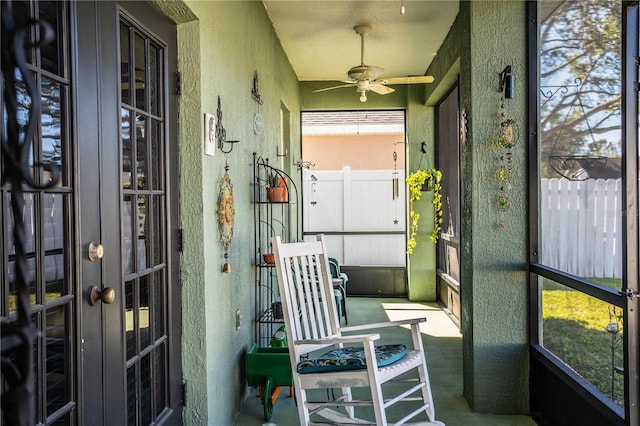 sunroom / solarium featuring ceiling fan